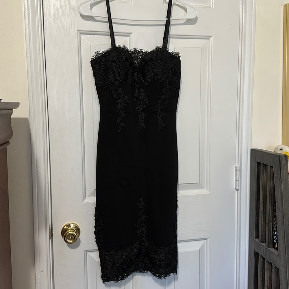 Black with embellished applications size small. With gold zipper down the back